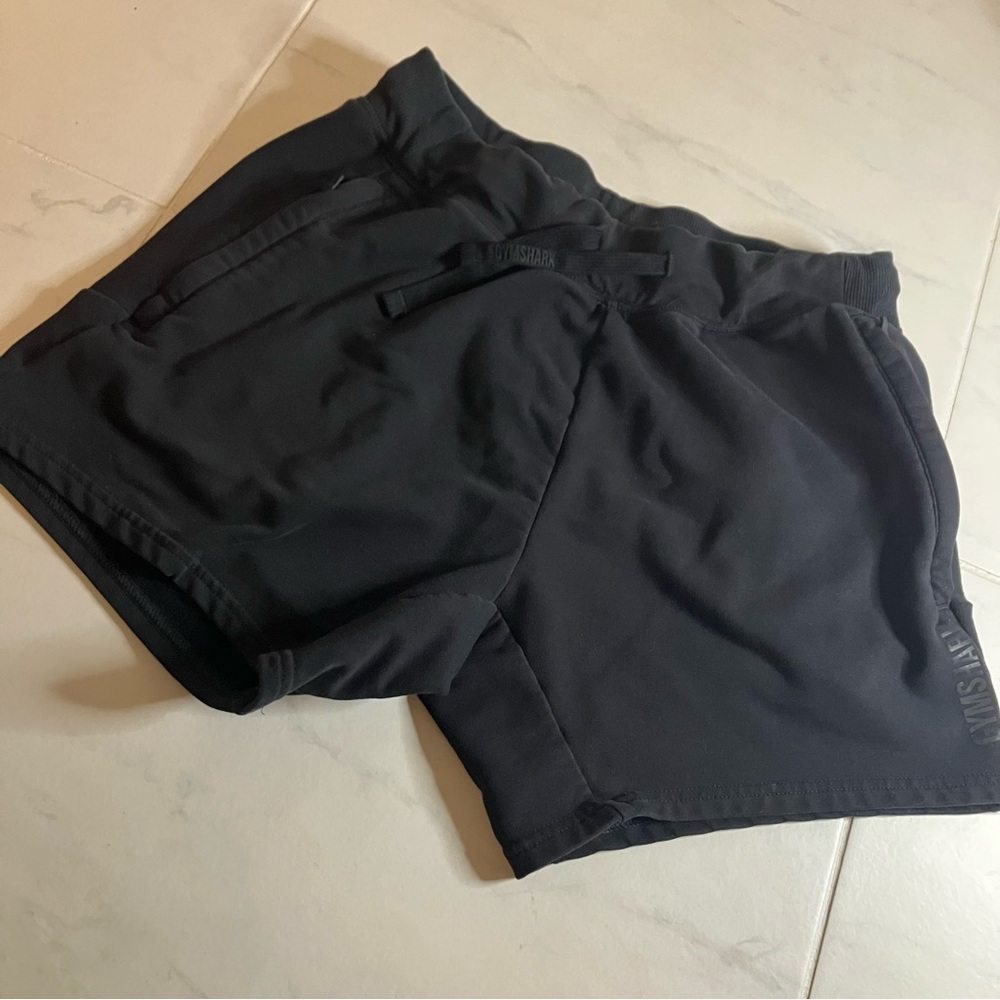 Gymshark Black sweatshirt material Athletic Shorts. Waist tie. Zipper pockets.